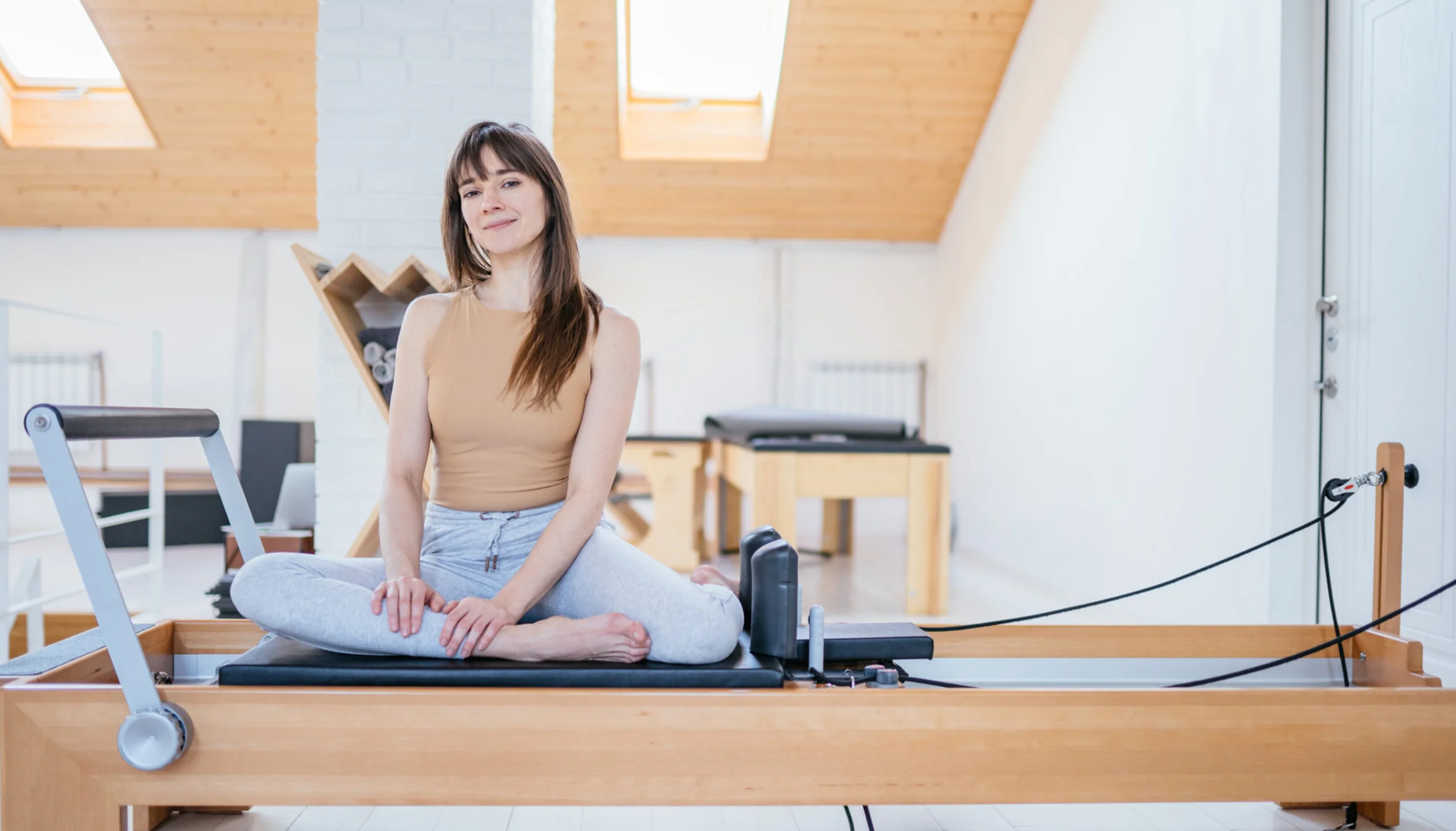 Woman on pilates reformer machine