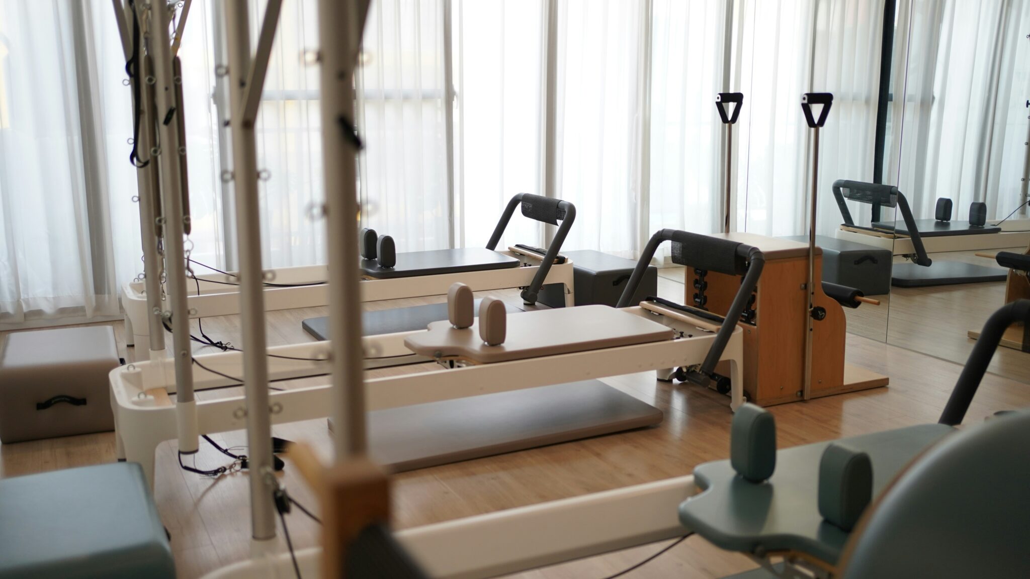 Empty Pilates reformer studio with bright window light