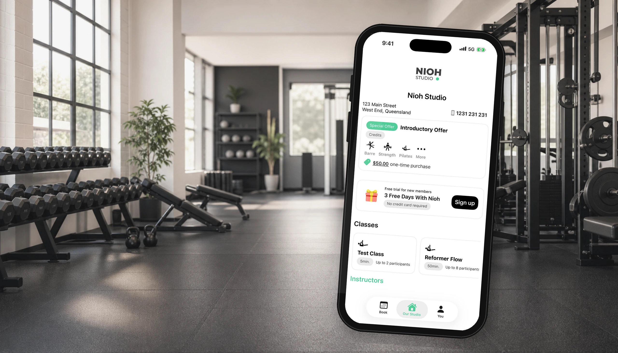 Phone showing the Nioh Studio booking app in a gym